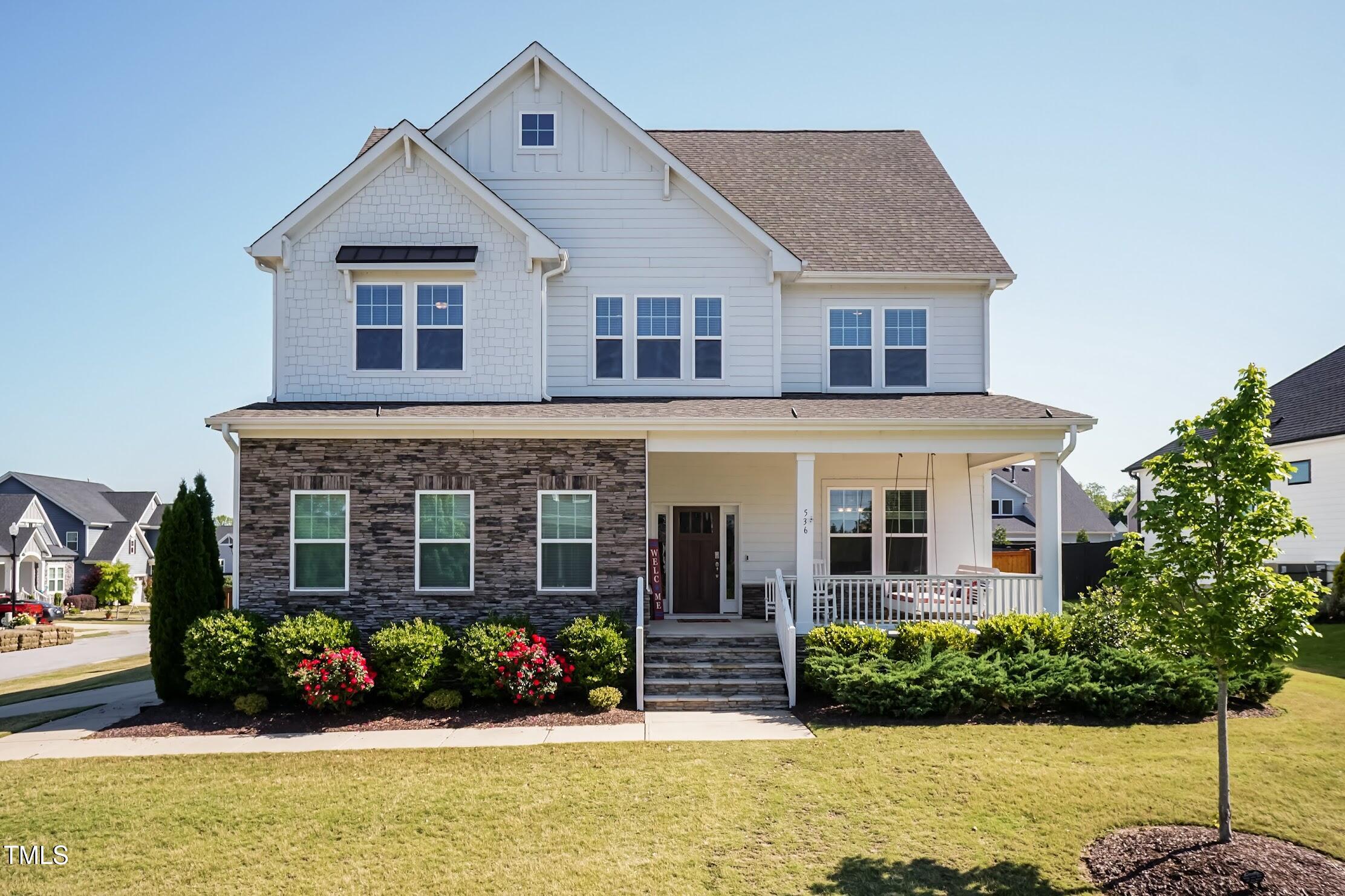 536 Adkins Ridge Road Rolesville, NC 27571 - Photo 1 of 52 a front view of a house with a yard and potted plants