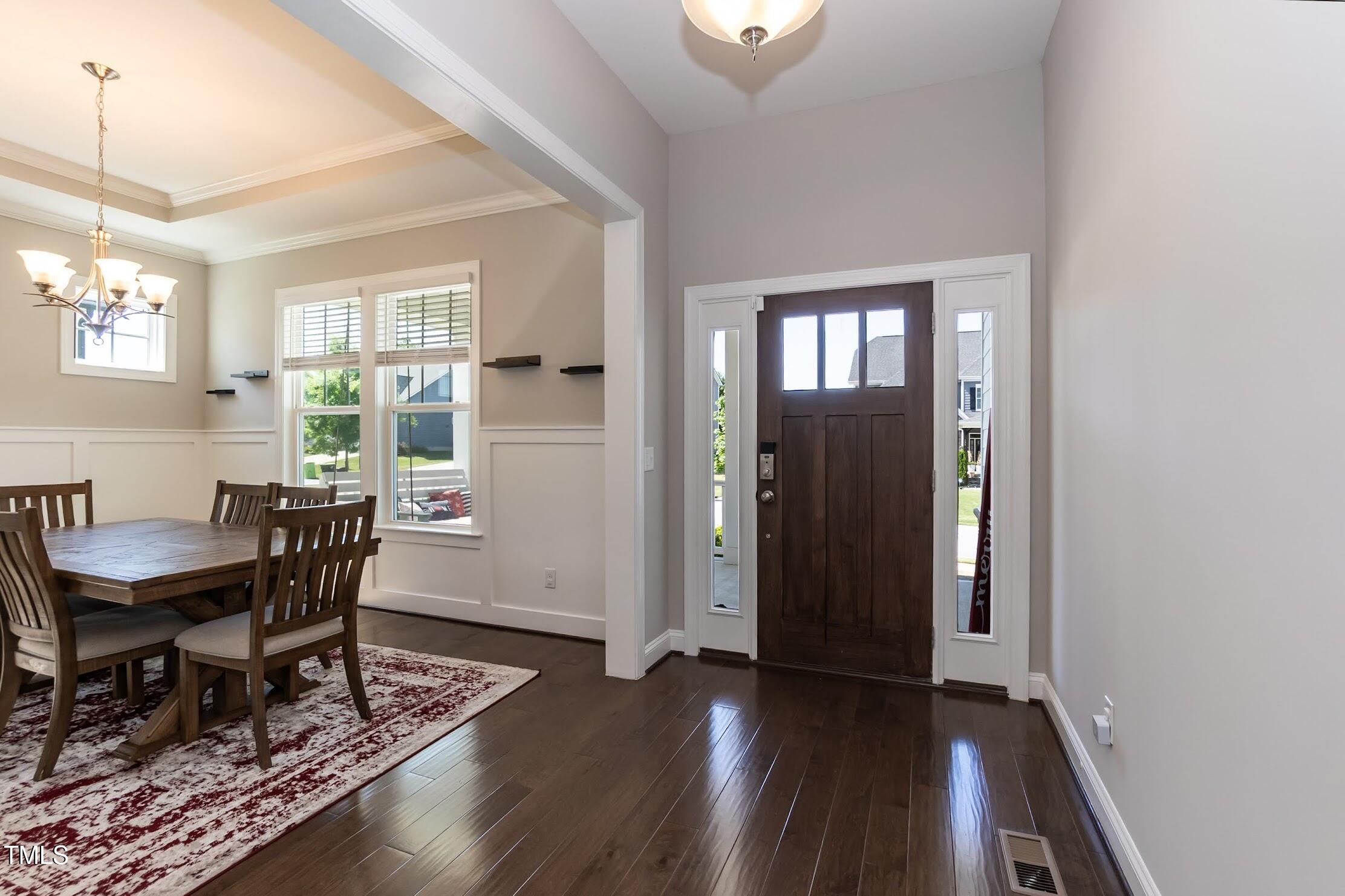536 Adkins Ridge Road Rolesville, NC 27571 - Photo 18 of 52 a view of a dining room with furniture window and wooden floor