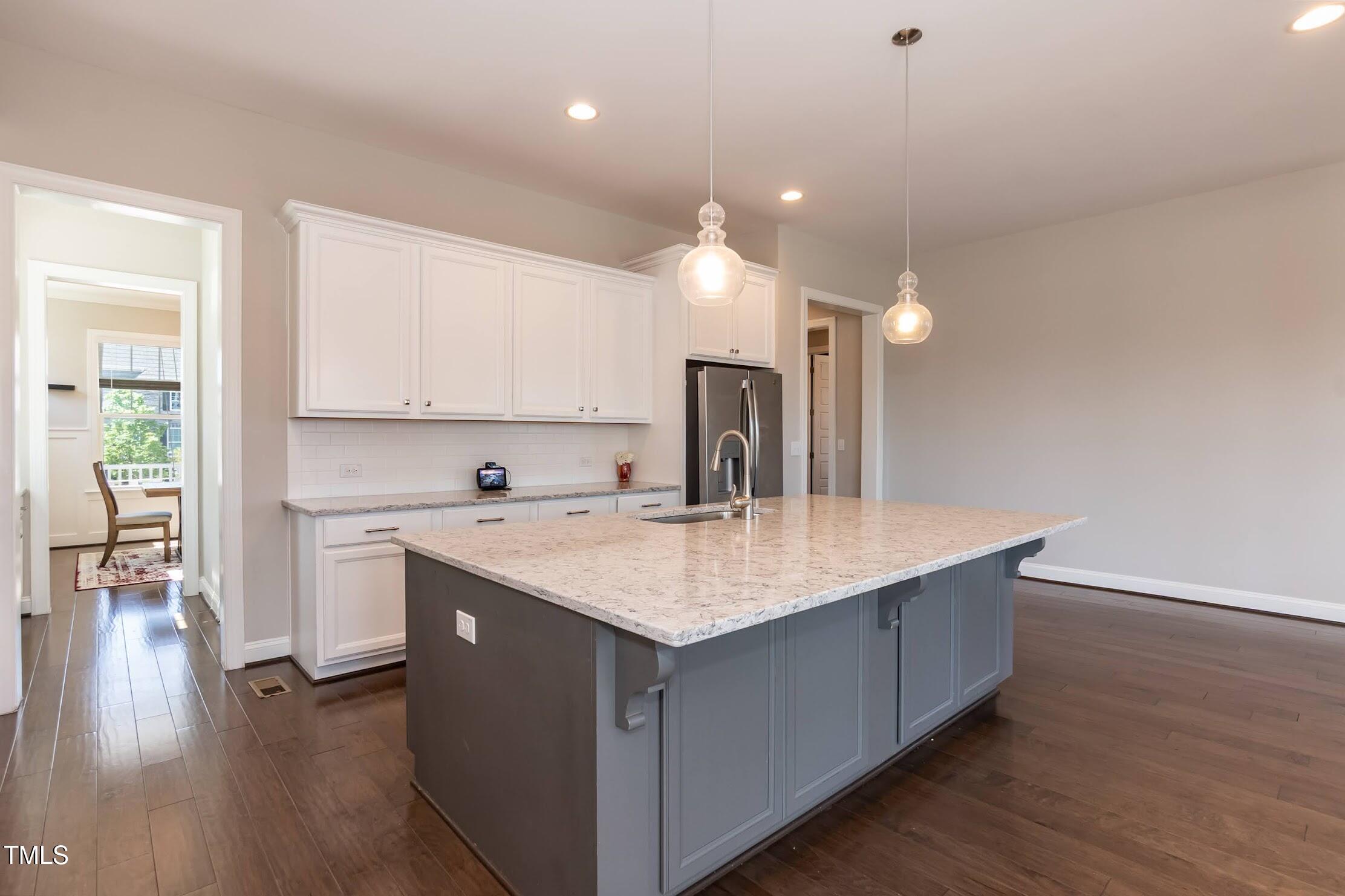 536 Adkins Ridge Road Rolesville, NC 27571 - Photo 24 of 52 a kitchen with a sink dishwasher a stove and a refrigerator with wooden floor