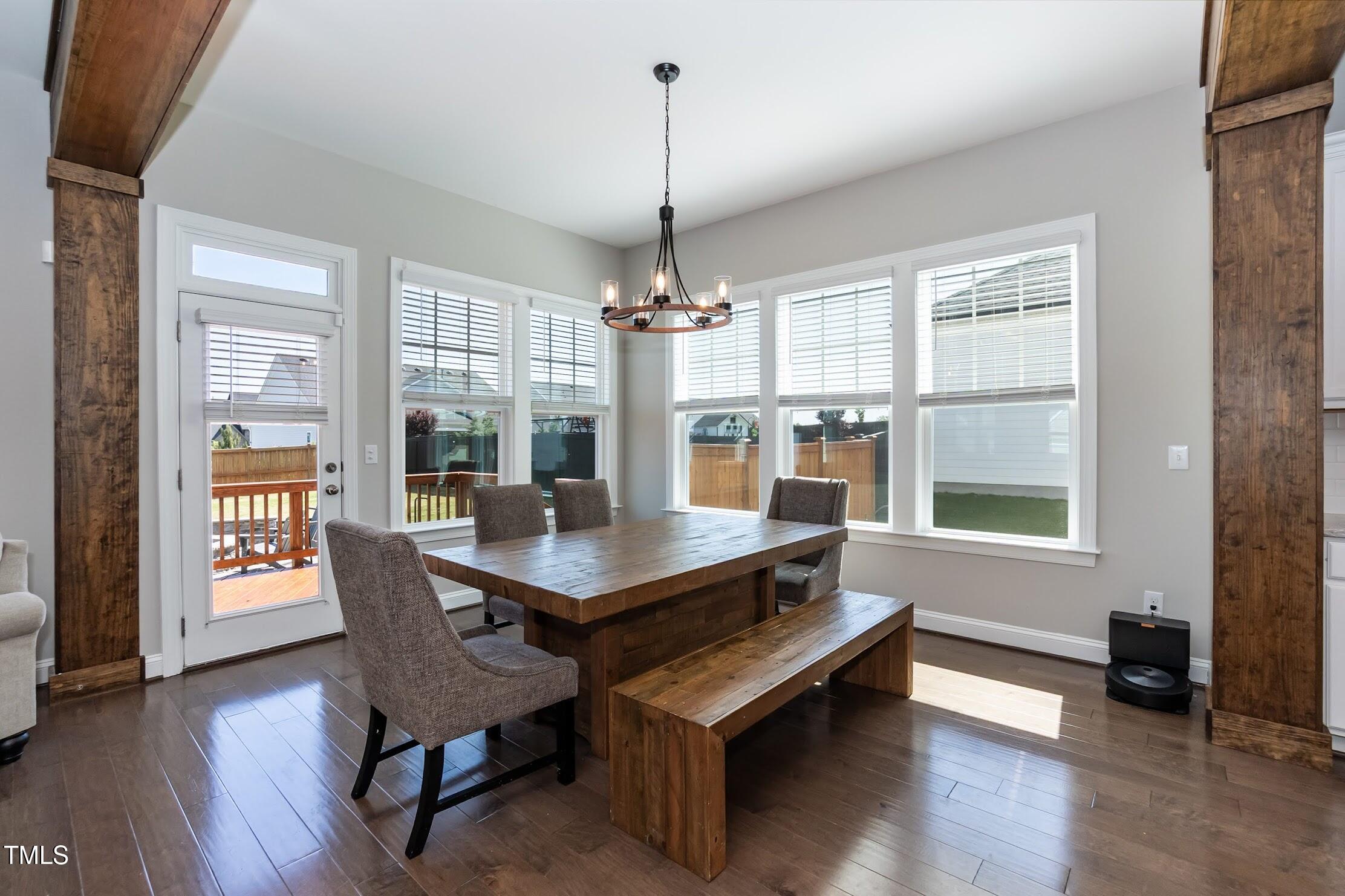 536 Adkins Ridge Road Rolesville, NC 27571 - Photo 28 of 52 a dining room with wooden floor a chandelier a wooden table and chairs