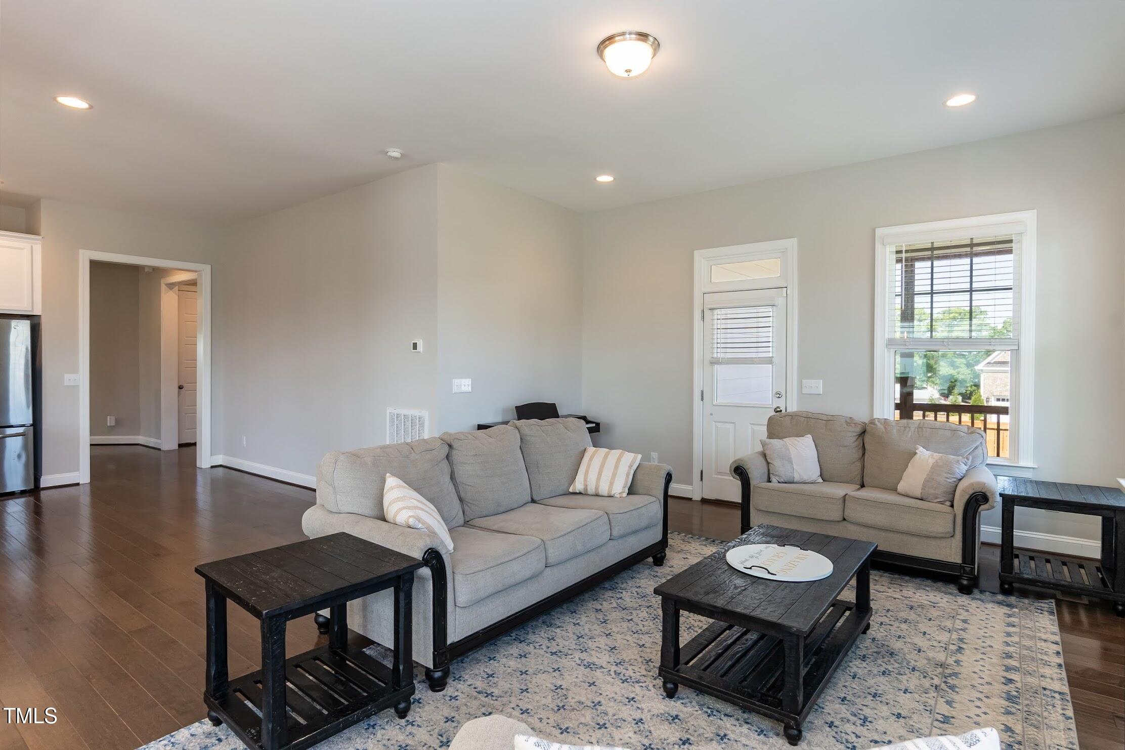 536 Adkins Ridge Road Rolesville, NC 27571 - Photo 29 of 52 a living room with furniture and a wooden floor