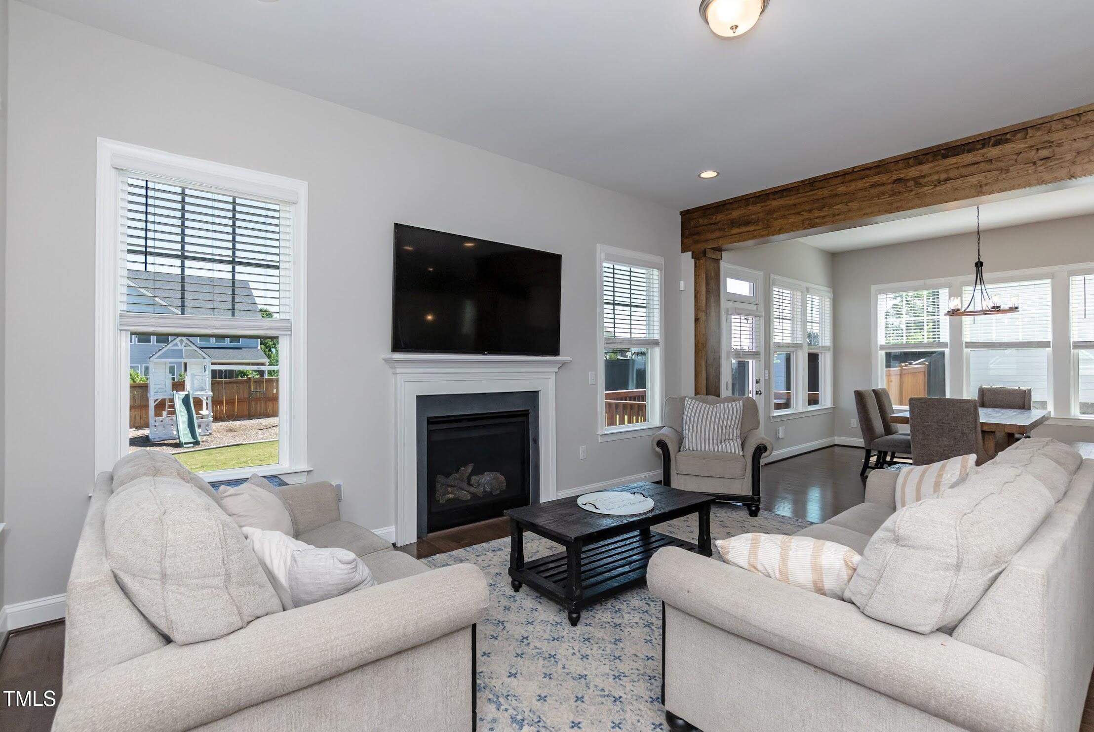 536 Adkins Ridge Road Rolesville, NC 27571 - Photo 31 of 52 a living room with furniture a flat screen tv and a fireplace