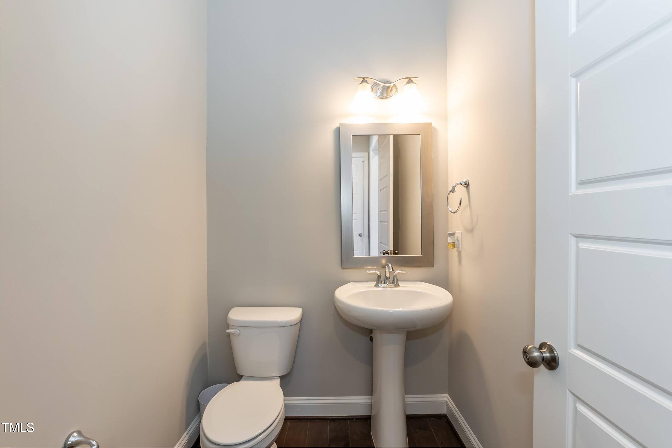 536 Adkins Ridge Road Rolesville, NC 27571 - Photo 33 of 52 a bathroom with a sink toilet and a mirror