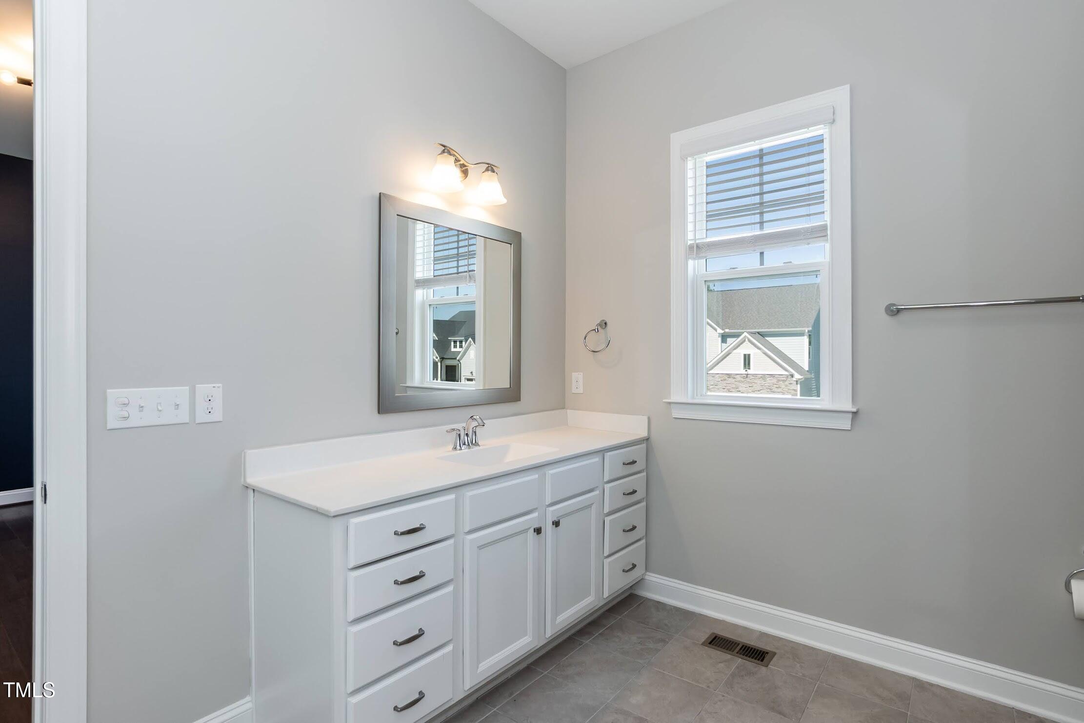 536 Adkins Ridge Road Rolesville, NC 27571 - Photo 36 of 52 a bathroom with a sink a vanity and a mirror
