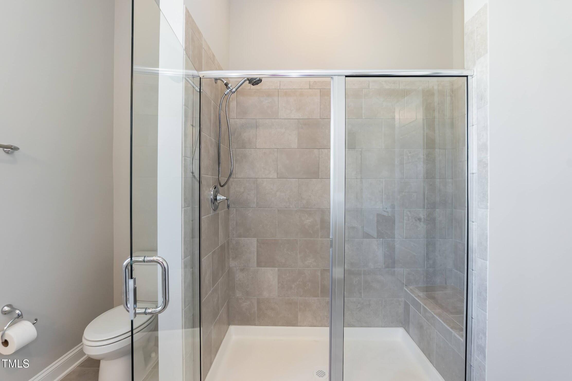 536 Adkins Ridge Road Rolesville, NC 27571 - Photo 37 of 52 a bathroom with a shower and a toilet