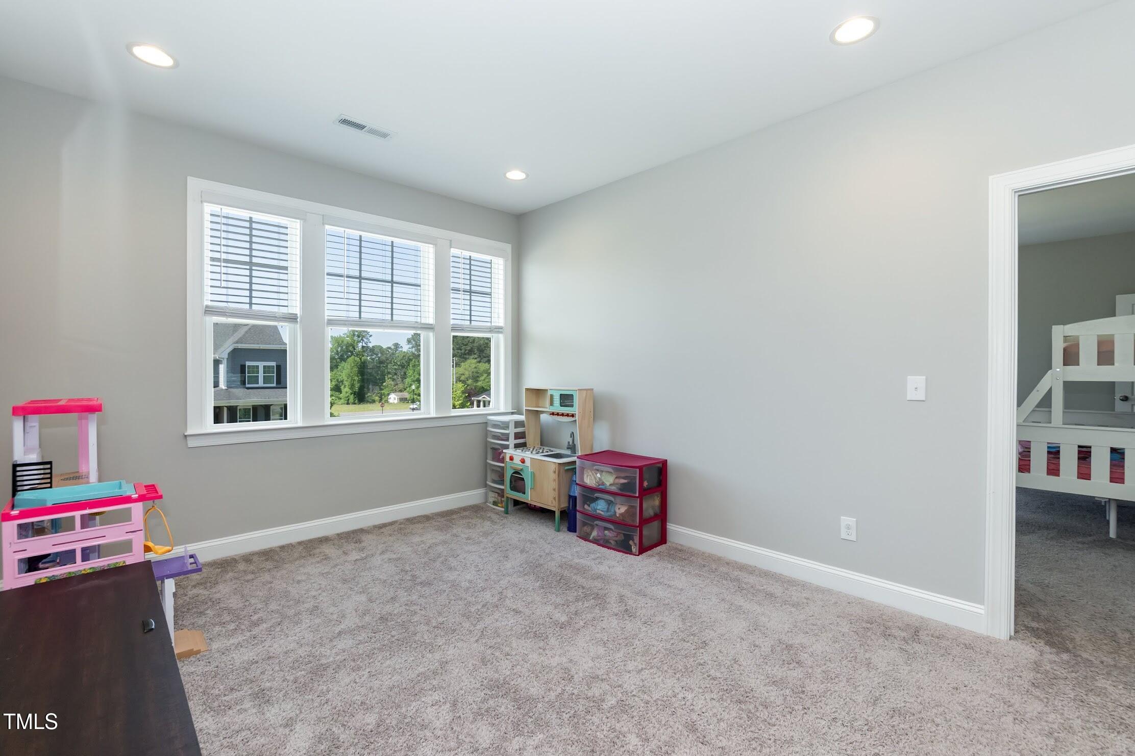 536 Adkins Ridge Road Rolesville, NC 27571 - Photo 40 of 52 an empty room with piano and wooden floor