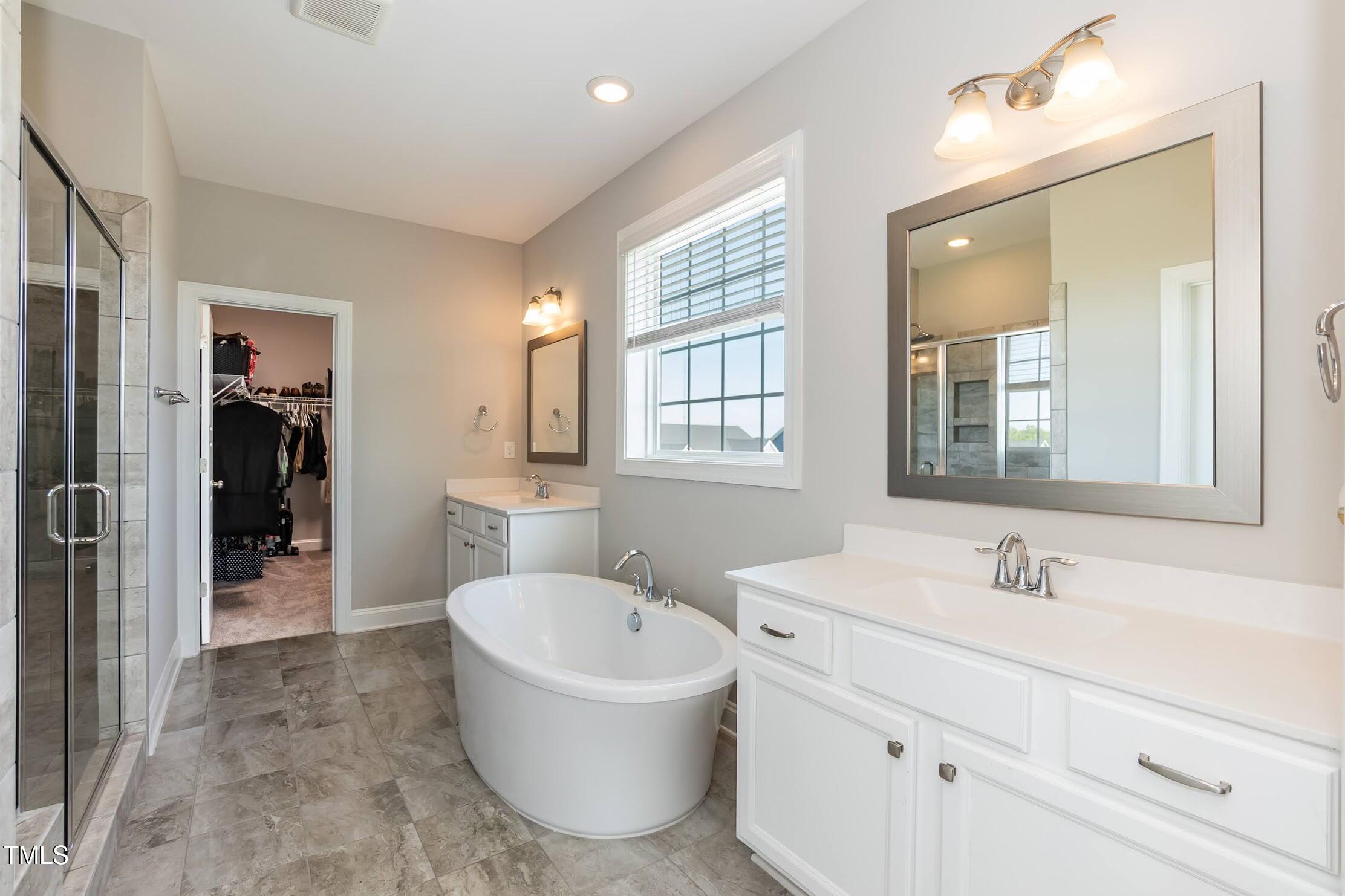 536 Adkins Ridge Road Rolesville, NC 27571 - Photo 49 of 52 a bathroom with a bathtub sink and mirror