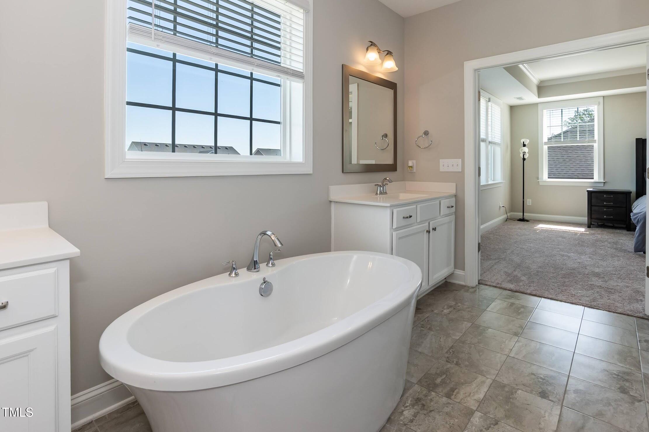 536 Adkins Ridge Road Rolesville, NC 27571 - Photo 51 of 52 a white bath tub sitting in a bathroom next to a sink