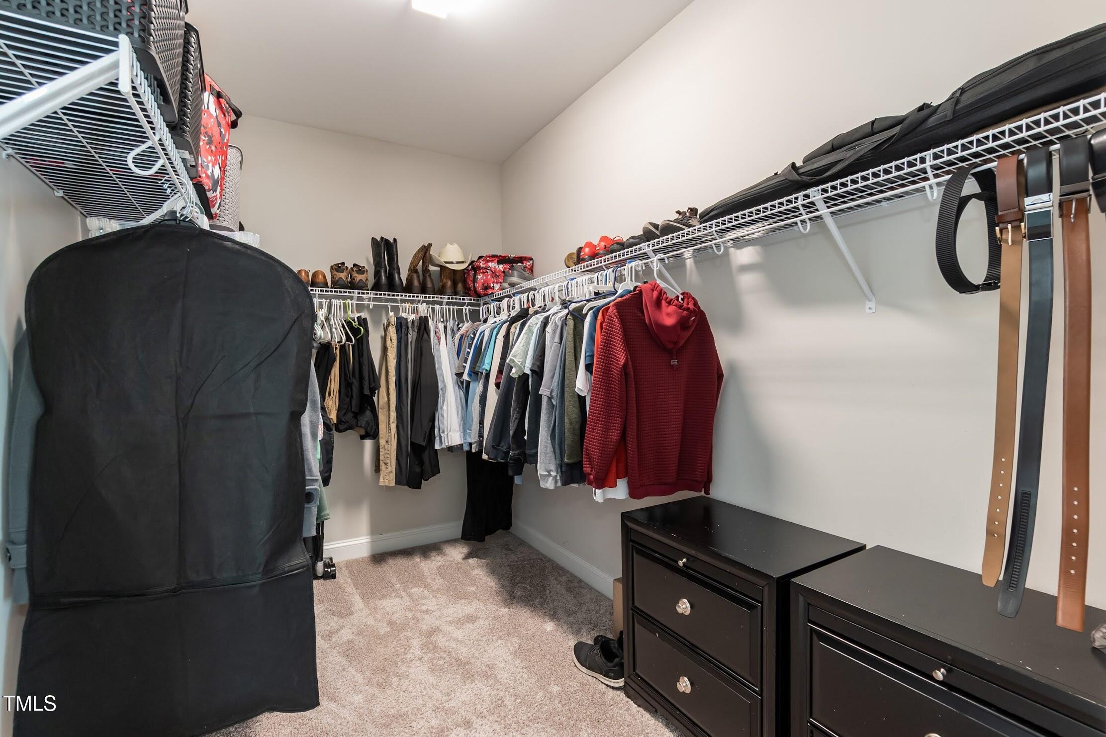 536 Adkins Ridge Road Rolesville, NC 27571 - Photo 52 of 52 a view of walk in closet with clothes and shoes