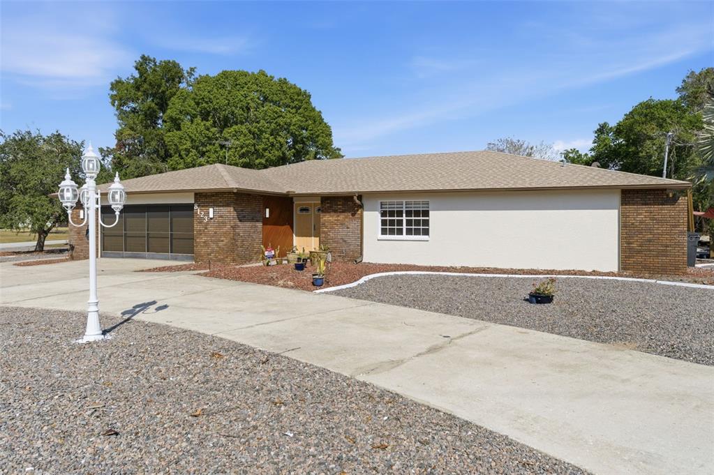 8123 River Country Drive Weeki Wachee, FL 34607 - Photo 1 of 61 a front view of a house with a yard