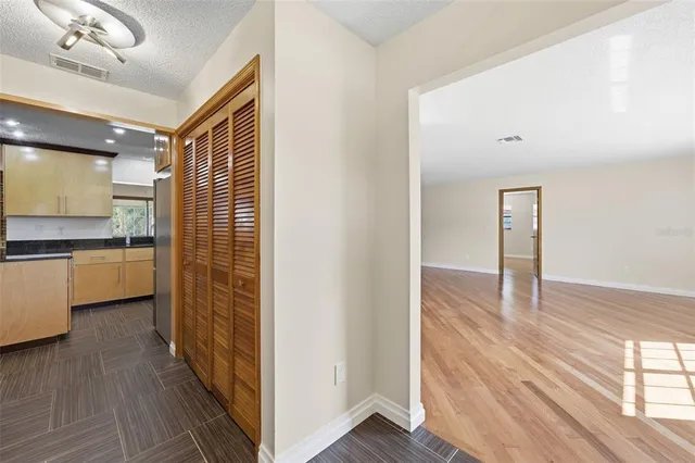 a view of a kitchen with a sink and wooden floor