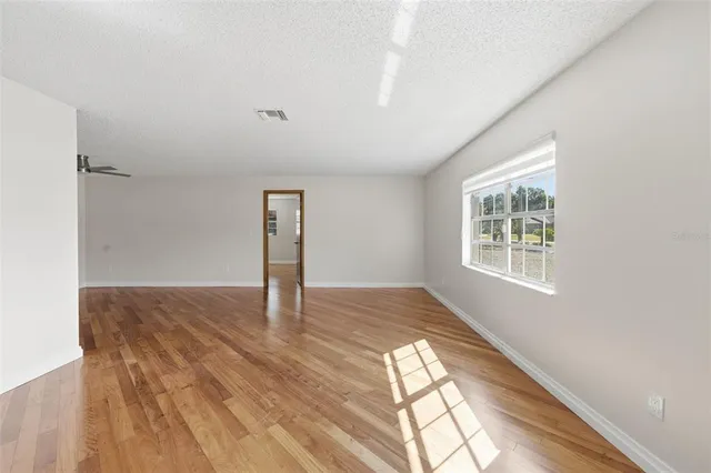 a view of a hallway with wooden floor and workspace