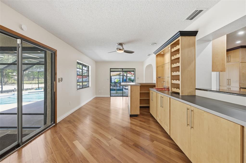 8123 River Country Drive Weeki Wachee, FL 34607 - Photo 28 of 61 a view of a kitchen with a sink and wooden floor