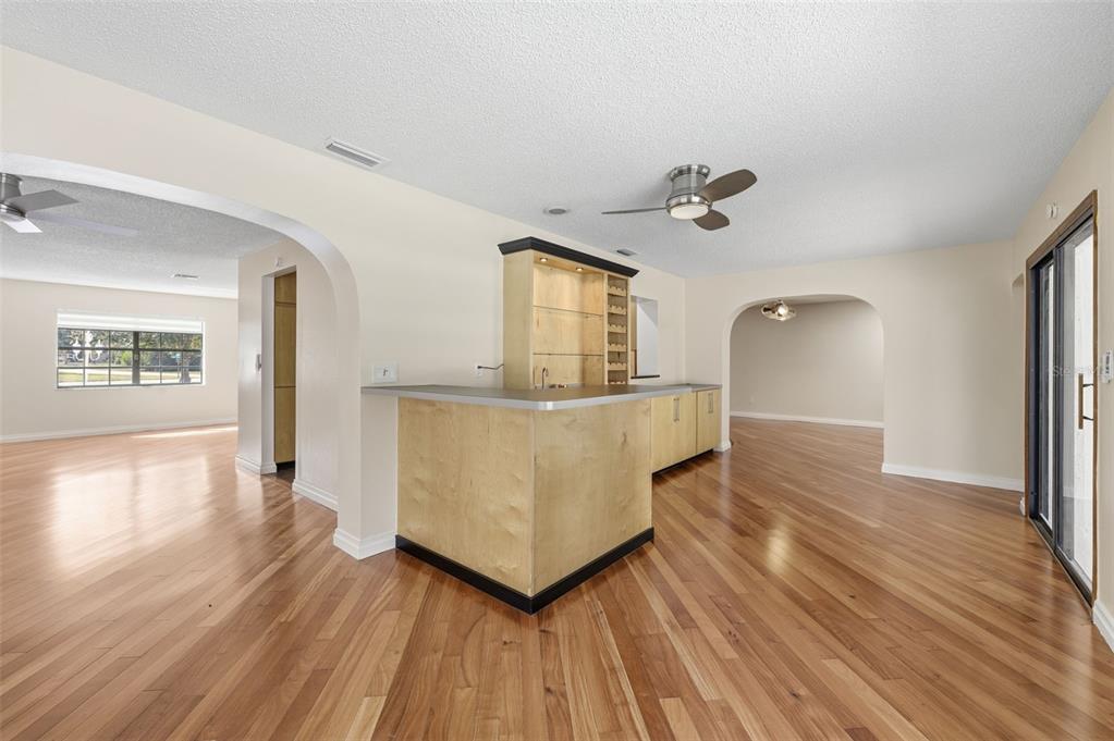 8123 River Country Drive Weeki Wachee, FL 34607 - Photo 31 of 61 a view of a living room with hardwood floor and a ceiling fan