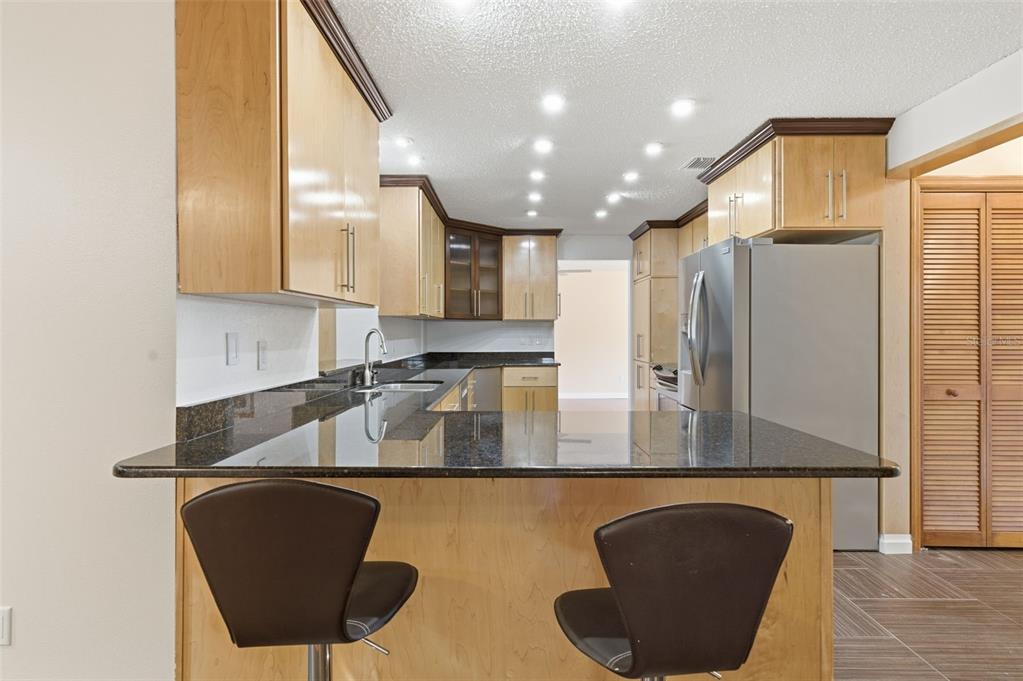 8123 River Country Drive Weeki Wachee, FL 34607 - Photo 34 of 61 a kitchen with stainless steel appliances granite countertop a sink a refrigerator and a stove