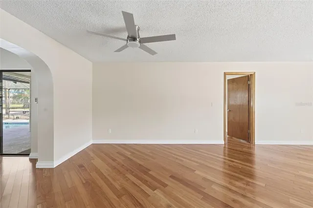 a view of a room with wooden floor and a window