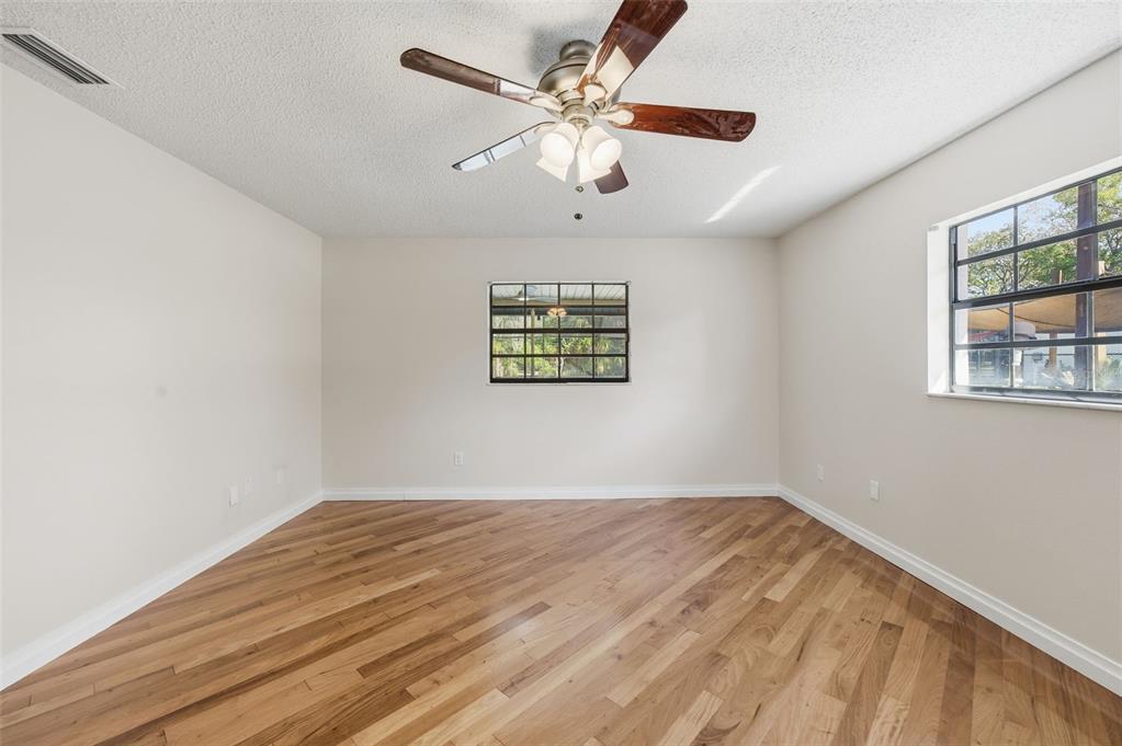8123 River Country Drive Weeki Wachee, FL 34607 - Photo 41 of 61 a view of a big room with wooden floor and windows