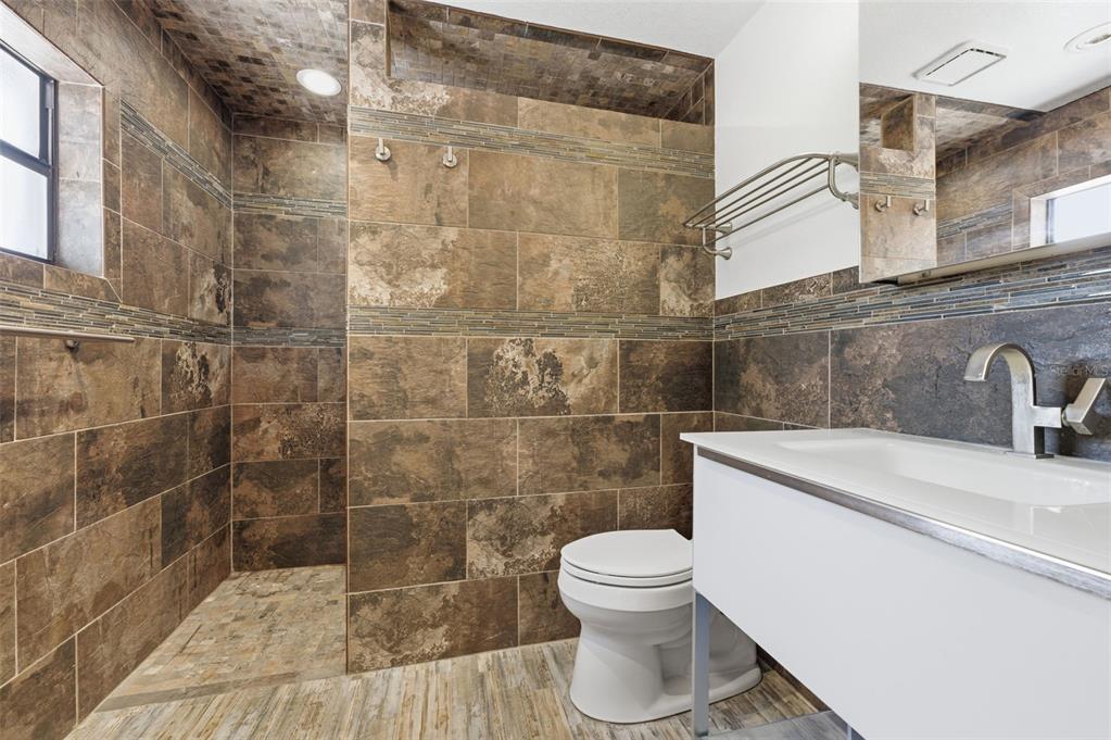 8123 River Country Drive Weeki Wachee, FL 34607 - Photo 43 of 61 a bathroom with a sink a toilet and a shower