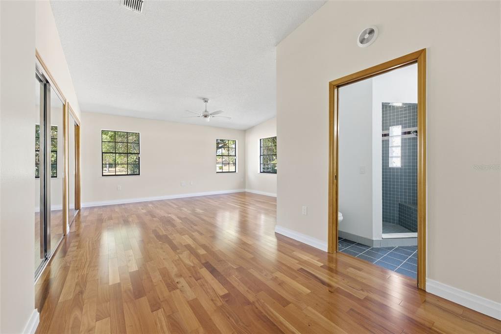 8123 River Country Drive Weeki Wachee, FL 34607 - Photo 52 of 61 an empty room with wooden floor and windows