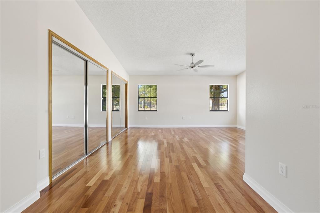 8123 River Country Drive Weeki Wachee, FL 34607 - Photo 53 of 61 a view of an empty room with wooden floor and a window