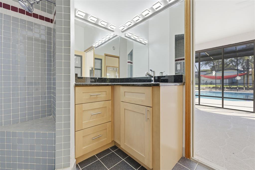 8123 River Country Drive Weeki Wachee, FL 34607 - Photo 56 of 61 a view of a bathroom with a sink and mirror