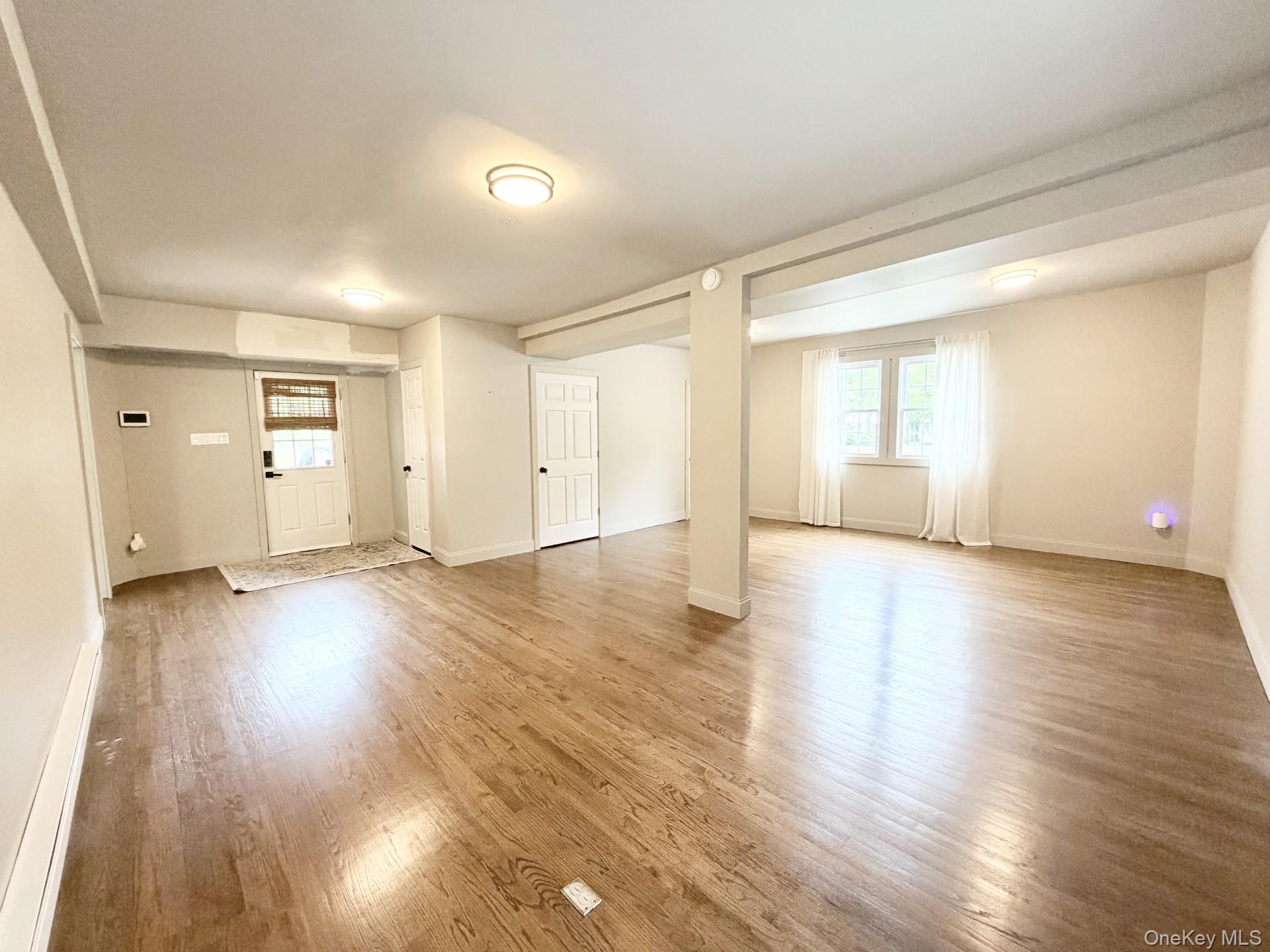 4 Lower Trinity Pass Road Pound Ridge, NY 10576 - Photo 10 of 29 an empty room with wooden floor and windows