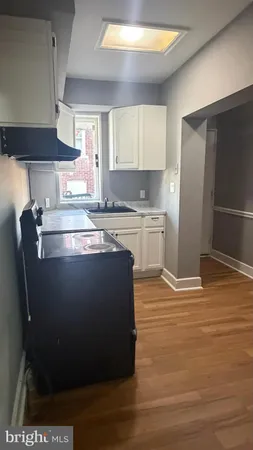 a view of room with window and wooden floor