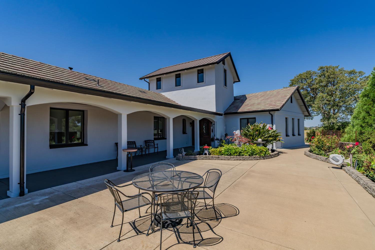 15070 Willow Creek Road Ione, CA 95640 - Photo 11 of 66 a view of a house with backyard sitting area and garden