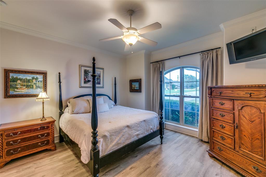 1237 Overlook Court Whitney, TX 76692 - Photo 13 of 39 a bedroom with a large bed a flat tv screen and dresser
