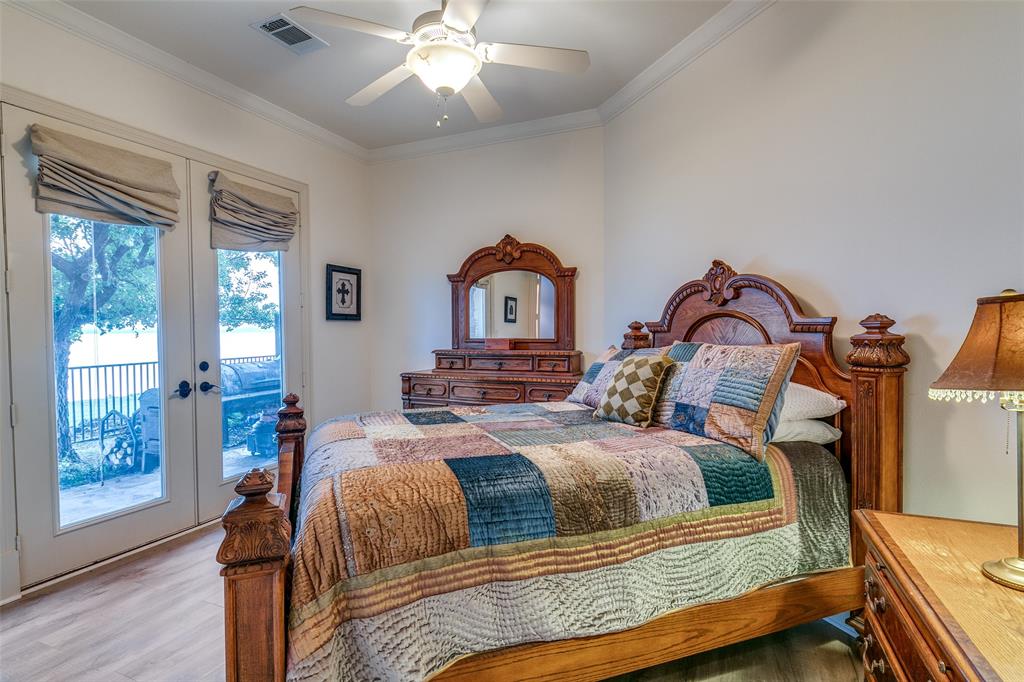 1237 Overlook Court Whitney, TX 76692 - Photo 15 of 39 a bedroom with a bed and wooden floor