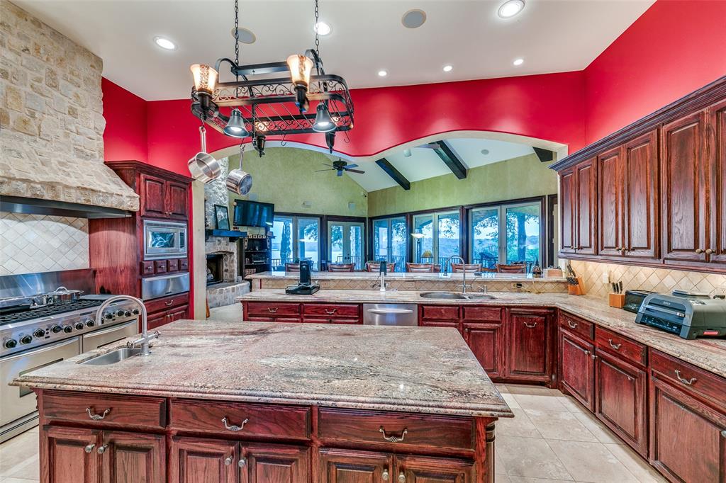1237 Overlook Court Whitney, TX 76692 - Photo 31 of 39 a kitchen with stainless steel appliances granite countertop a stove a sink and a refrigerator
