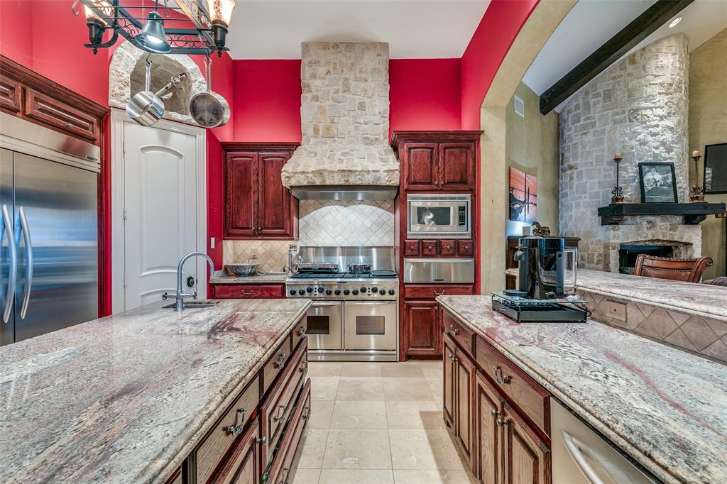 1237 Overlook Court Whitney, TX 76692 - Photo 32 of 39 a kitchen with stainless steel appliances granite countertop a stove top oven a sink a counter space and cabinets