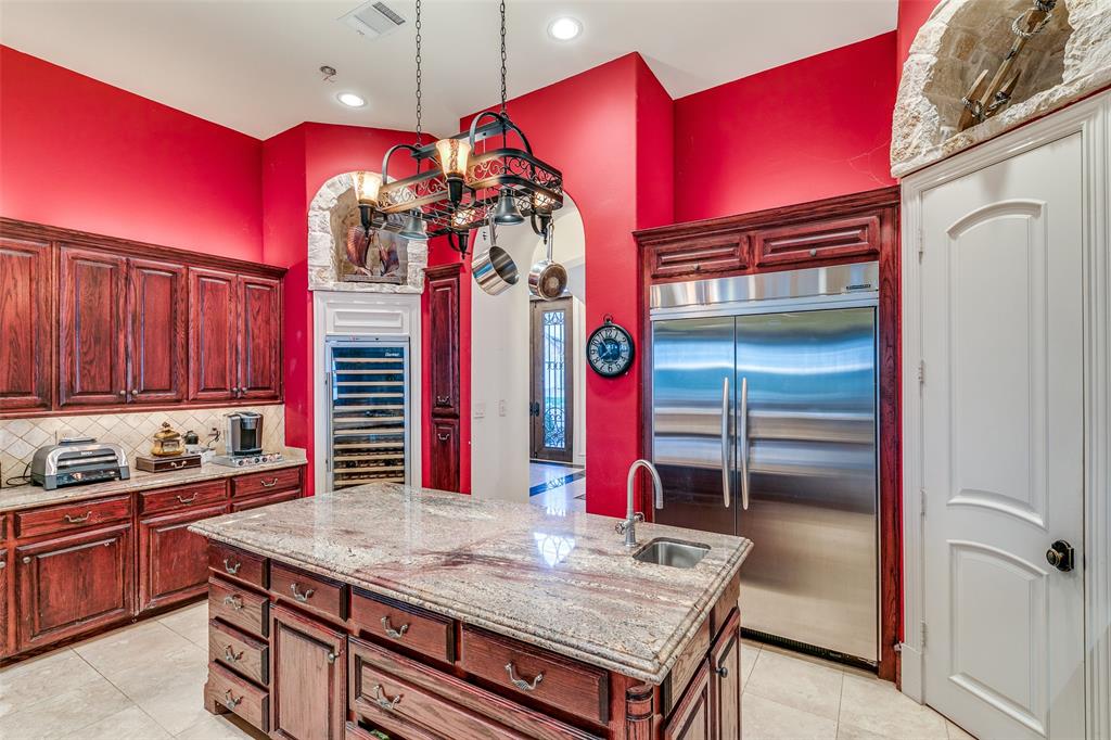 1237 Overlook Court Whitney, TX 76692 - Photo 33 of 39 a kitchen with stainless steel appliances granite countertop a kitchen counter space and wooden cabinets