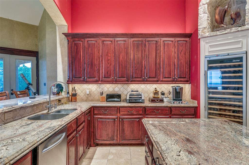 1237 Overlook Court Whitney, TX 76692 - Photo 34 of 39 a kitchen with stainless steel appliances granite countertop a sink stove and cabinets