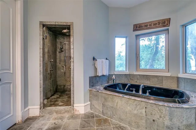a bathroom with a bathtub and a shower