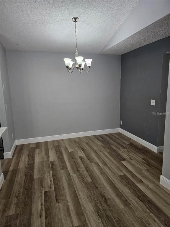 5132 Conroy Road, Unit 932 Orlando, FL 32811 - Photo 11 of 19 a view of empty room with wooden floor