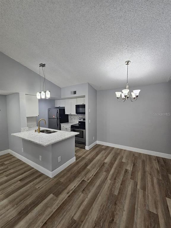 5132 Conroy Road, Unit 932 Orlando, FL 32811 - Photo 2 of 19 a view of kitchen with sink microwave and stove