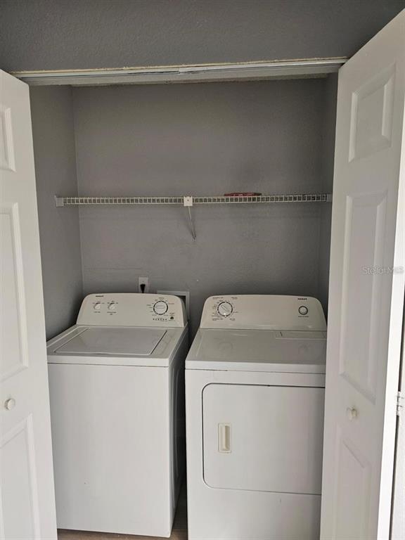 5132 Conroy Road, Unit 932 Orlando, FL 32811 - Photo 5 of 19 a utility room with dryer and washer