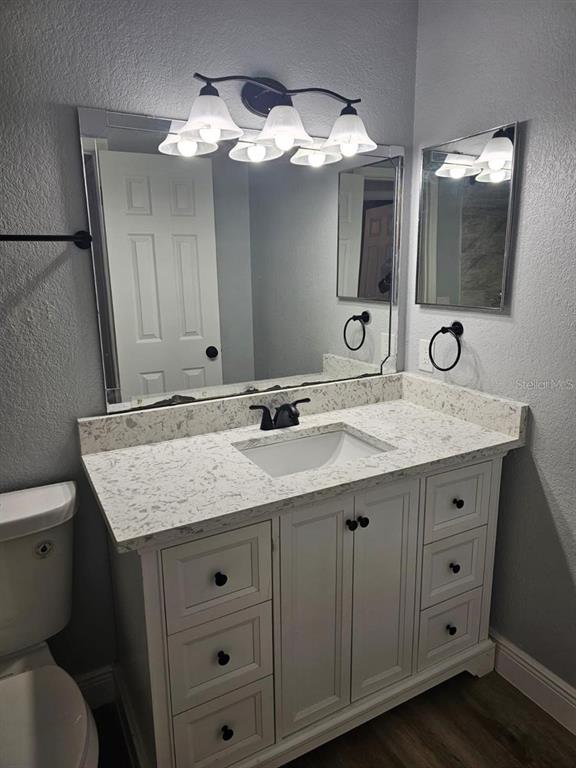 5132 Conroy Road, Unit 932 Orlando, FL 32811 - Photo 6 of 19 a bathroom with a granite countertop sink and a mirror