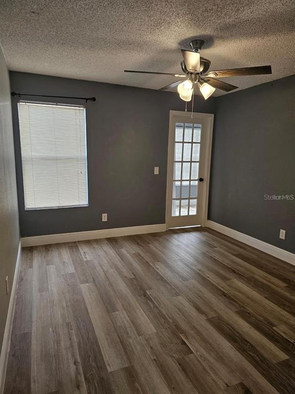 5132 Conroy Road, Unit 932 Orlando, FL 32811 - Photo 8 of 19 a view of an empty room with wooden floor and a window