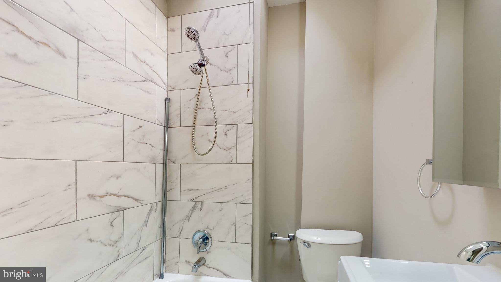 812 McCabe Avenue Baltimore, MD 21212 - Photo 13 of 18 a white toilet sitting next to a bath tub