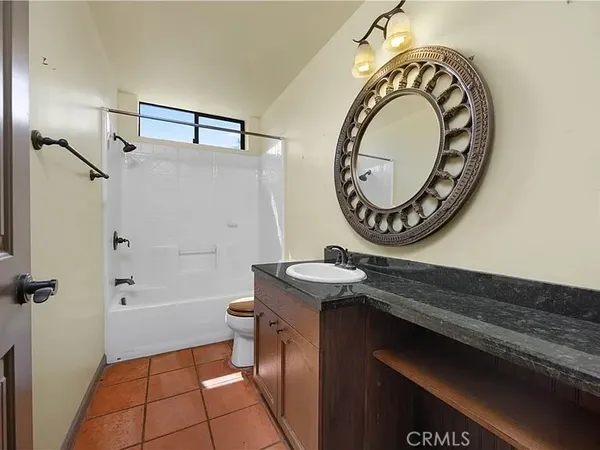 a bathroom with a sink a toilet and a shower