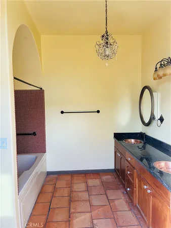 a bathroom with a sink a mirror and a bathtub