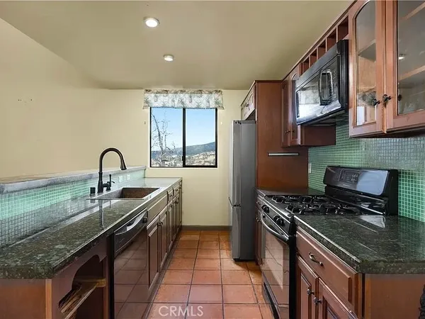 a kitchen with a sink and a stove top oven