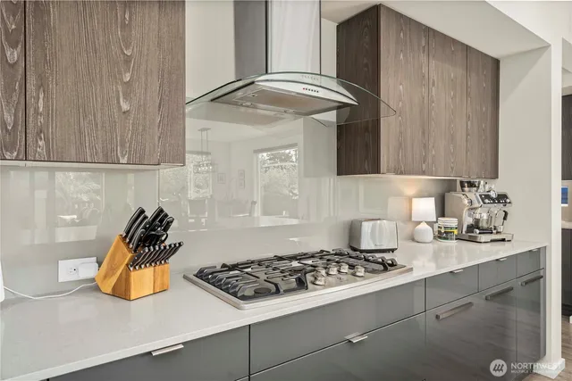 a kitchen with a sink a stove and cabinets
