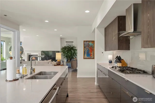 a kitchen with a sink and a stove top oven