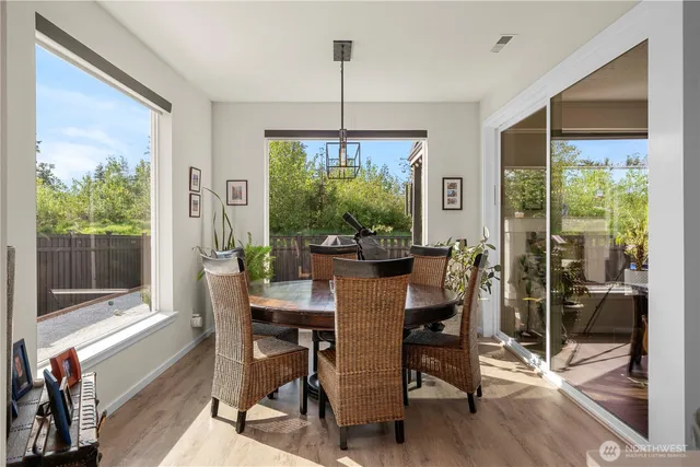 a view of a dining room with furniture window and wooden floor