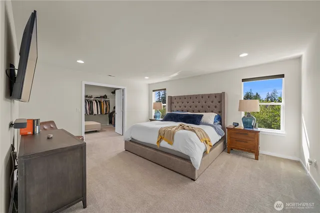 a view with a double vanity sink mirror and window