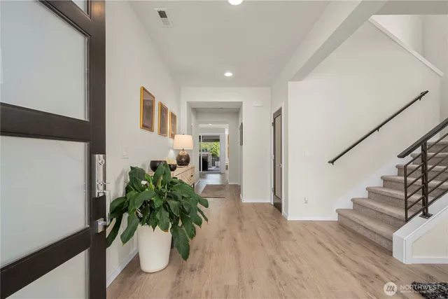 a view of entryway with wooden floor and a potted plant