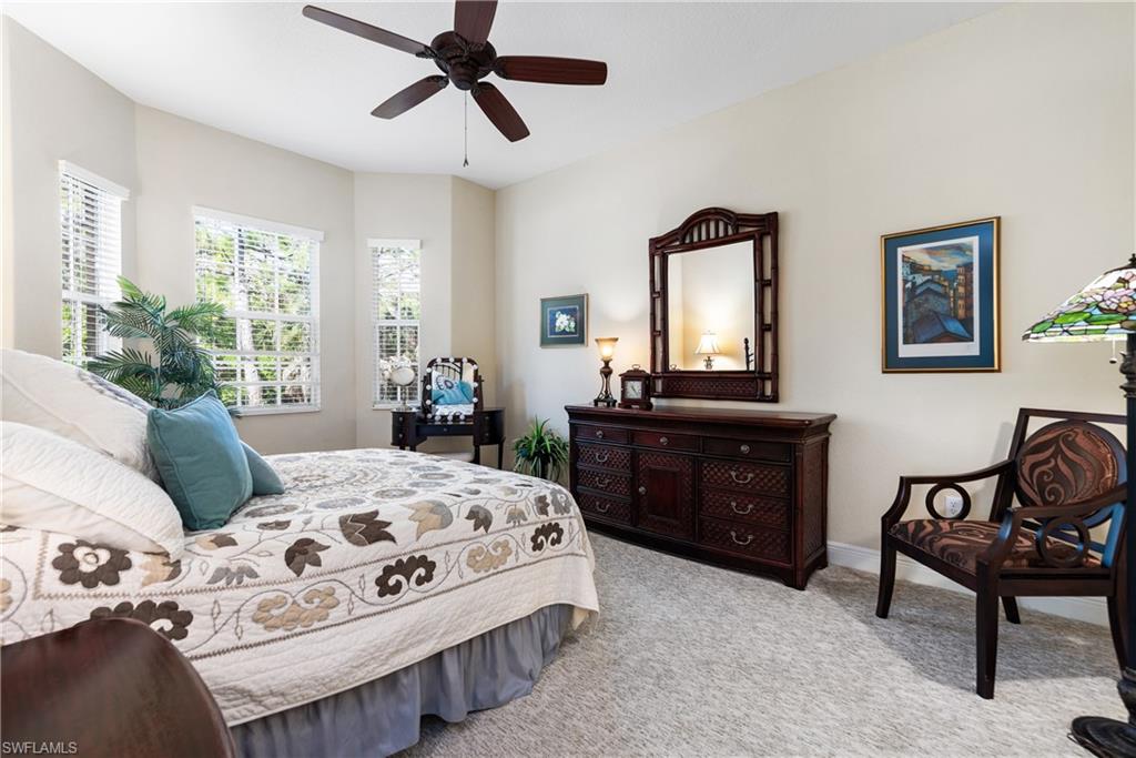 7837 Hawthorne Drive, Unit 1101 Naples, FL 34113 - Photo 11 of 26 a bedroom with a bed and a dresser